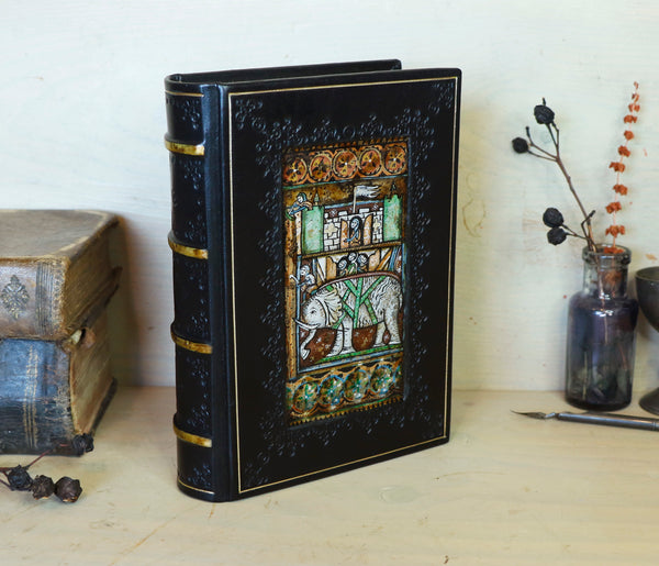 Black leather journal with painted Illuminated miniature and gold tooled decoration - Elephant and castle