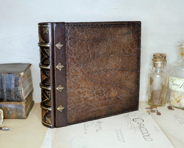 Large leather journal, Worn leather, Gold tooled decoration. The Old Book