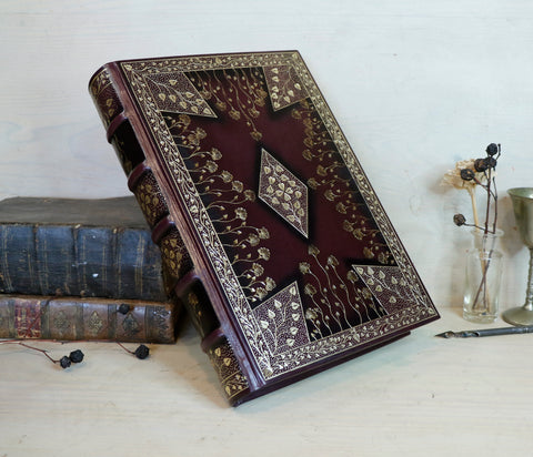 Dark Purple Leather Journal with gold tooled floral decoration. Gilded Reflections