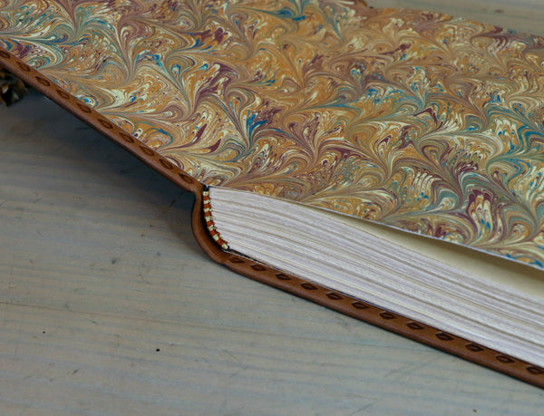 Antiqued brown leather journal with tooled decoration. The Cycle of Life