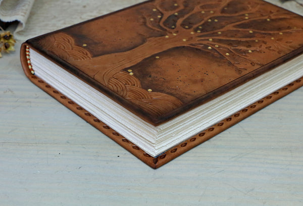 Antiqued brown leather journal with tooled decoration. The Cycle of Life