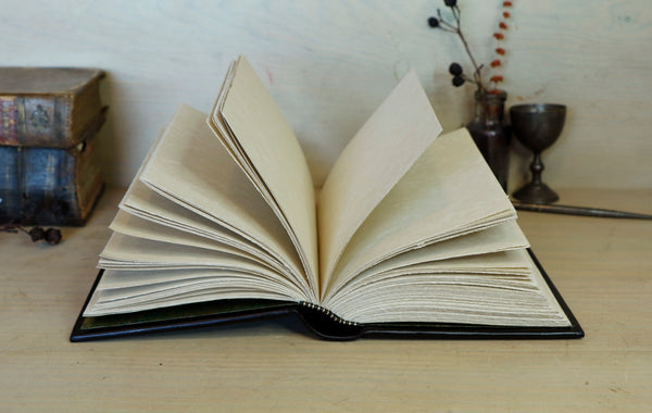 Black leather journal with painted Illuminated miniature and gold tooled decoration - Elephant and castle